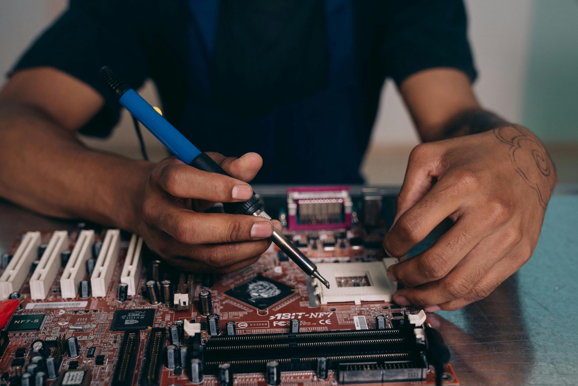 CCT Repairs technician repairing a circuit board